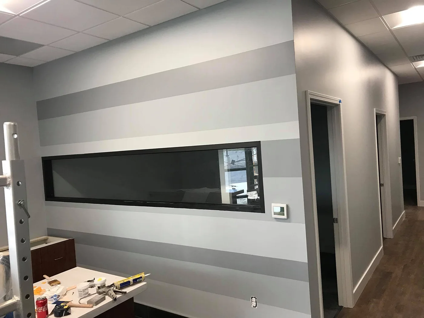 Office walls painted with a gray accent stripe