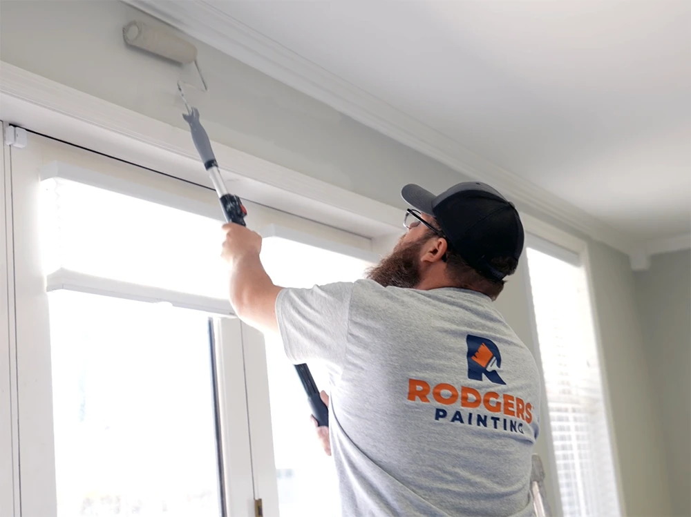 Interior Painter Rodgers Painting painter rolling paint on an interior wall