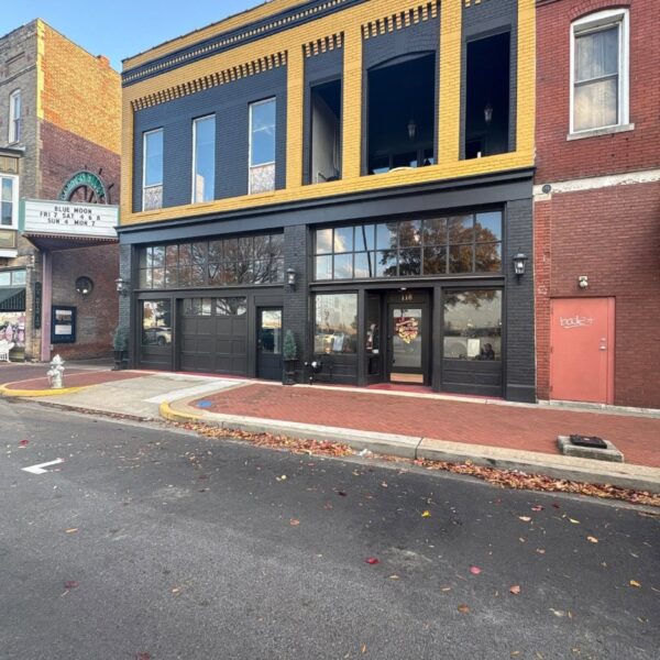 Downtown brick storefront painted black with yellow trim