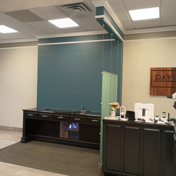 Jewelry store front desk with a teal painted feature wall