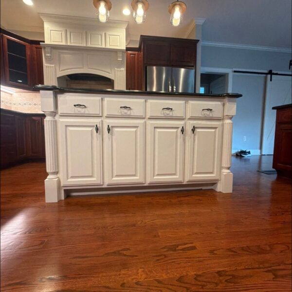 White Kitchen Island Kitchen island cabinets painted white with a granite top and barn door beyond