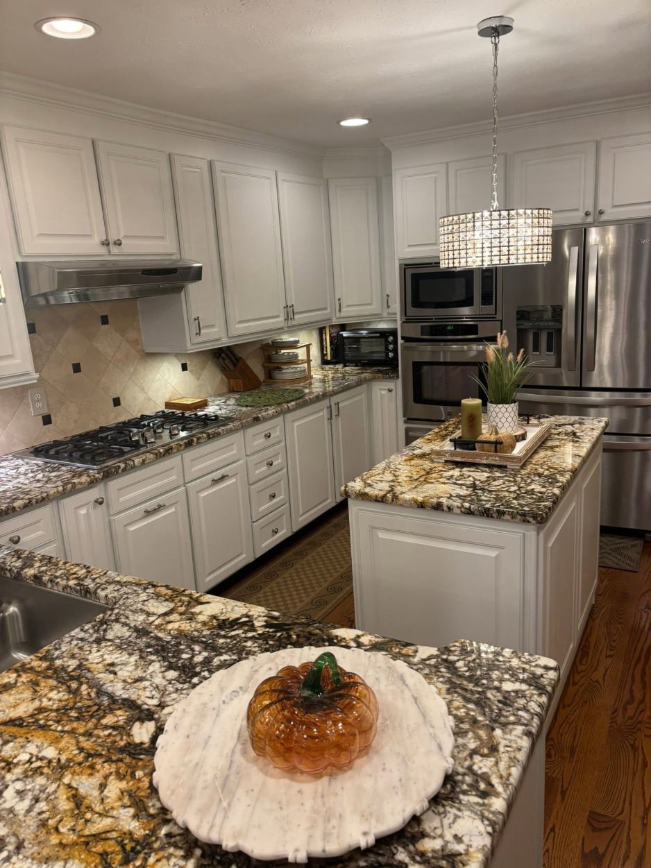 White Kitchen Cabinets Kitchen cabinets painted white around a granite topped island