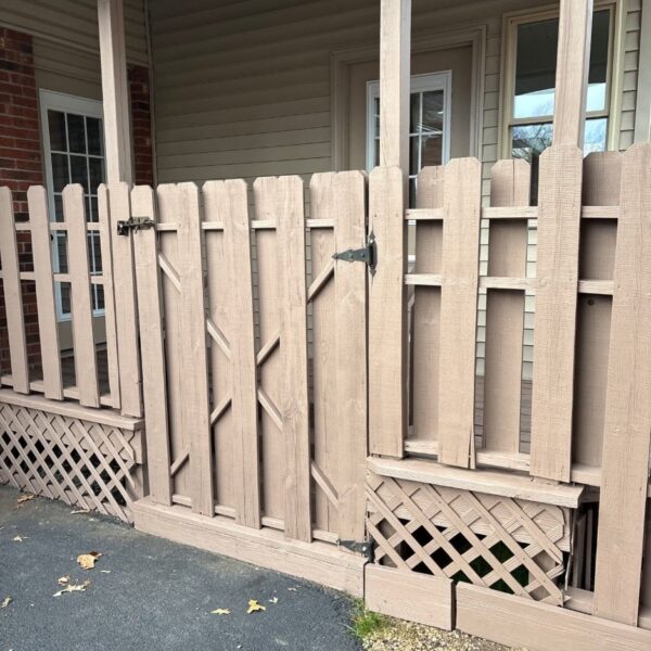 Stained Privacy Fence & Gate Wooden privacy fence and gate stained a uniform brown with lattice trim