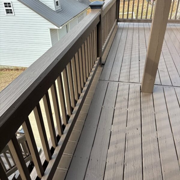 Upper Deck Railing Upper deck walkway with railing and boards stained a two tone brown